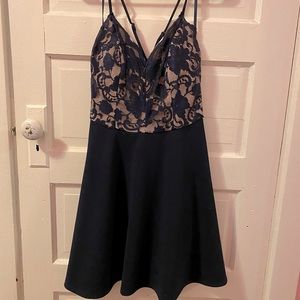 Woman’s navy blue sleeveless lace dress